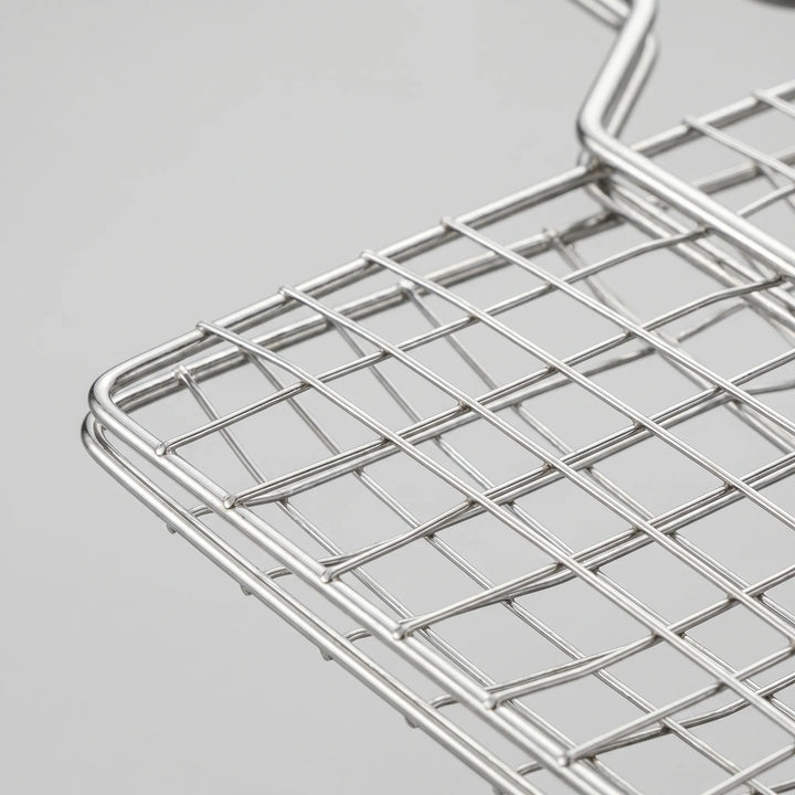 Durable outdoor cooking grill basket for campfire and BBQ. Securely holds food for easy flipping.
