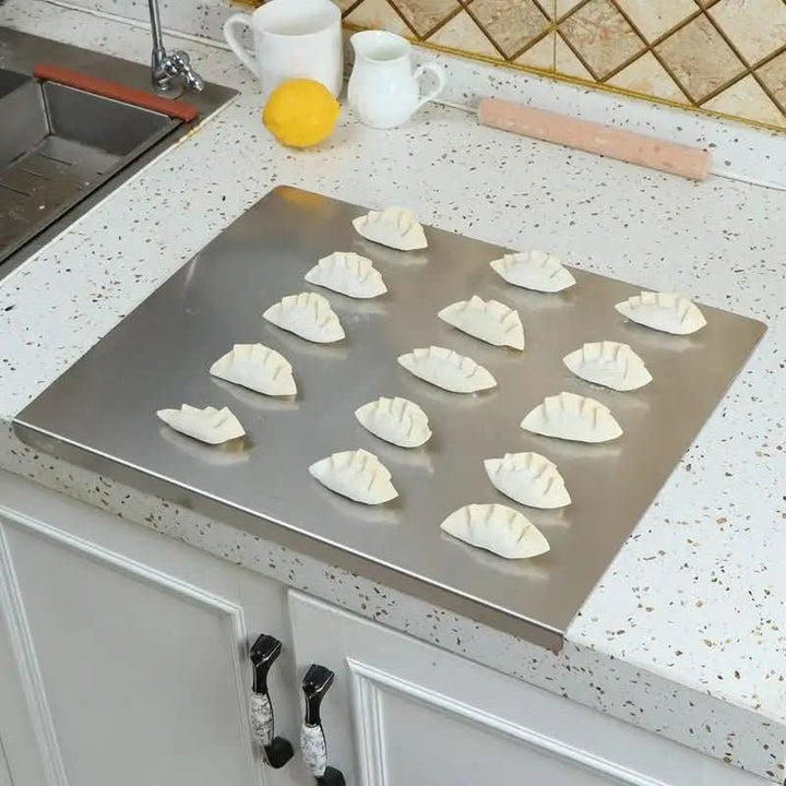 Professional kitchen cutting board, made from hygienic stainless steel with a non-slip butcher block design.