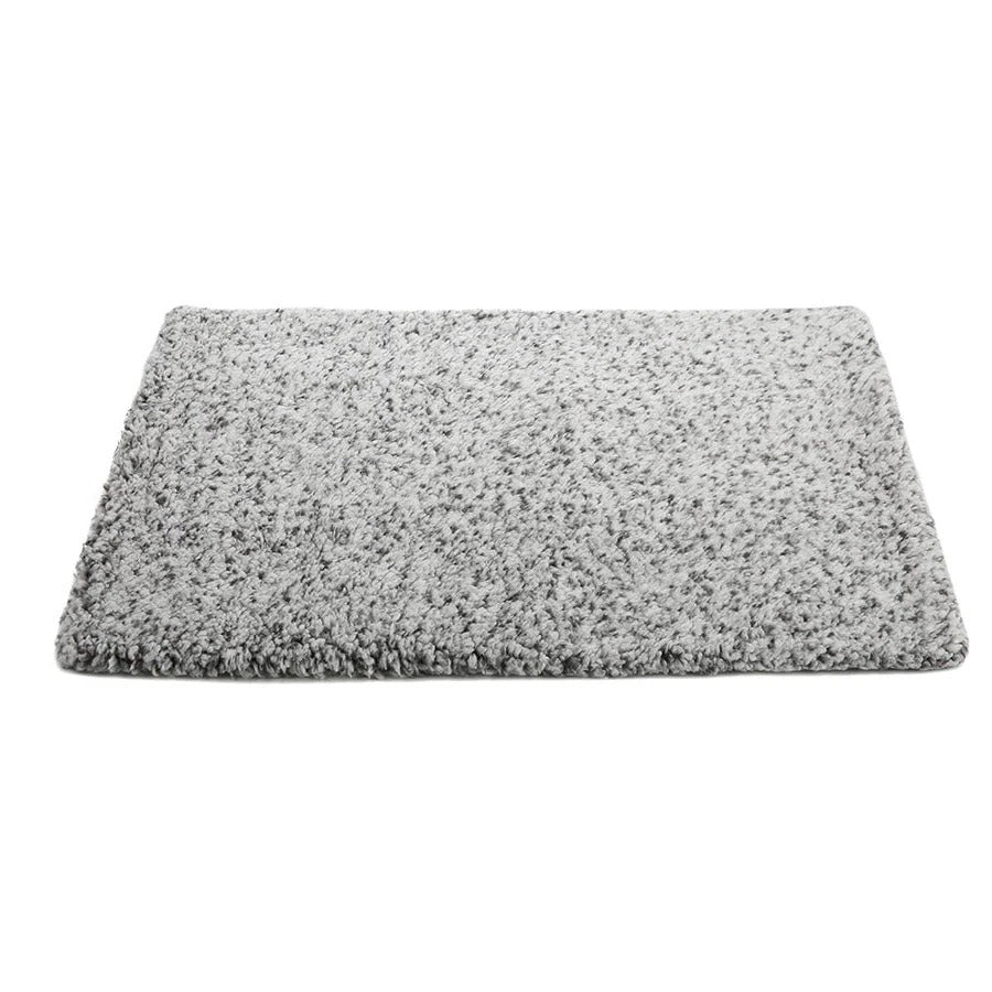 Happy cat napping on a cozy self-warming pet pad. Non-electric, washable for ultimate pet comfort.