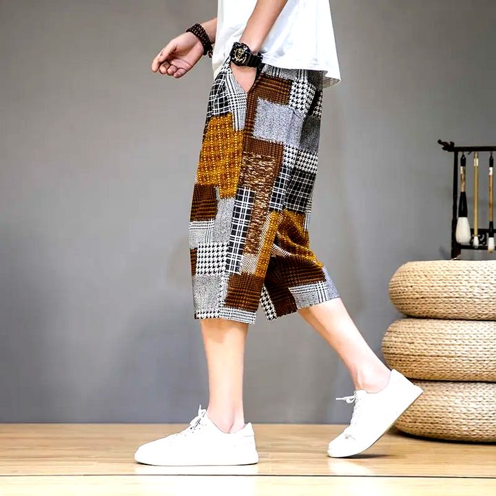 Flat lay: Men's unique patch capris shorts, showcasing full patch design, capri length, and casual streetwear style.