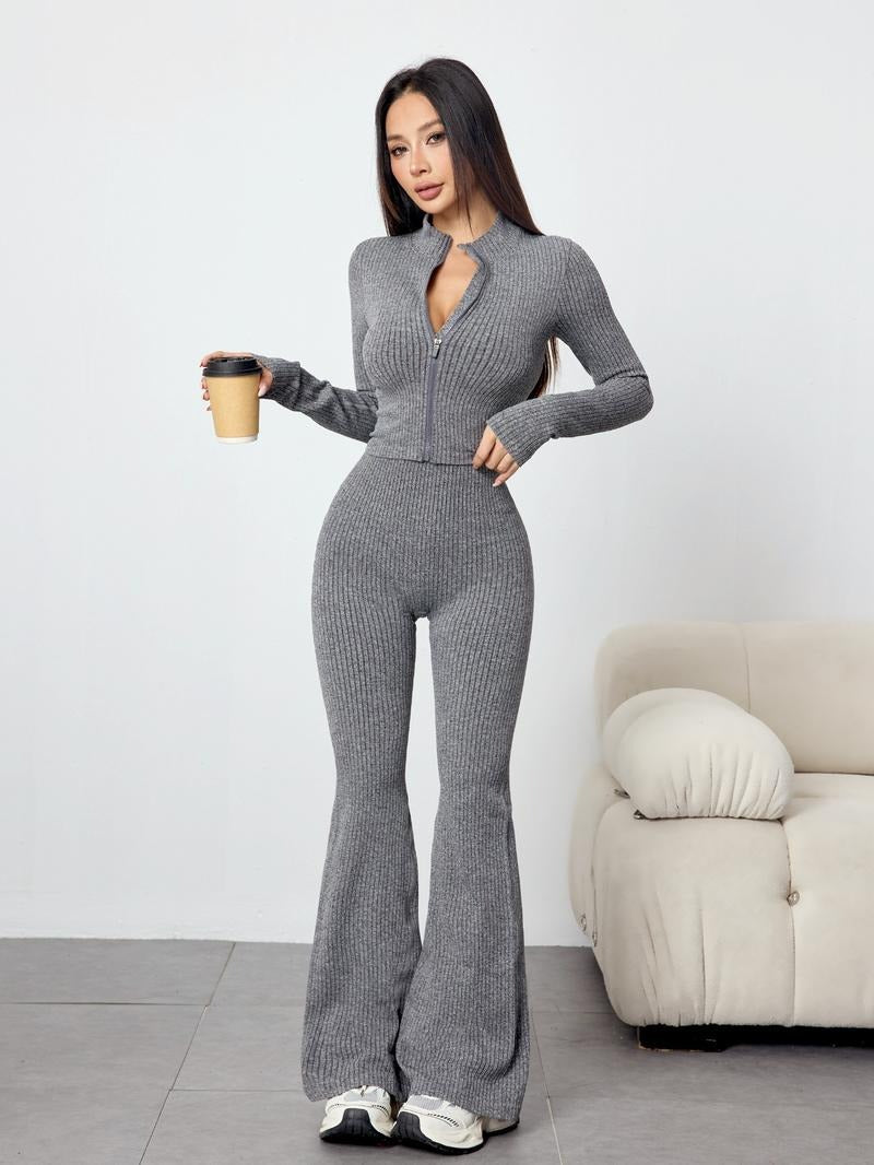 Close-up of women's ribbed knit two-piece set, highlighting texture of long sleeve top & flare pants.
