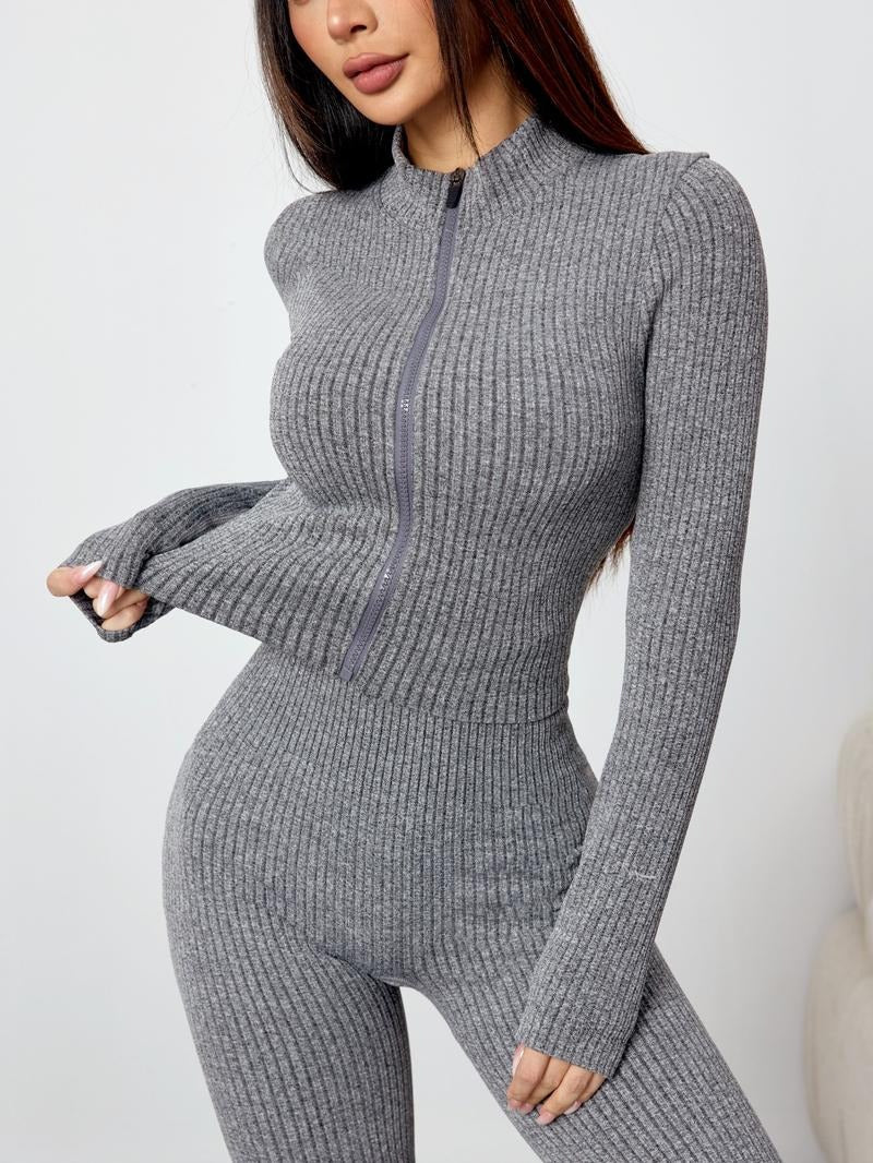 Flat lay of women's ribbed knit two-piece matching set with long sleeve top & comfortable flare pants.