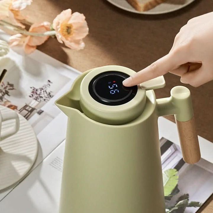 Insulated carafe for hot and cold drinks. Boasts a digital temp display & a natural wood handle.