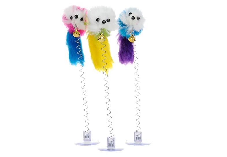 Cat batting at an interactive feather mouse toy, attached to a surface with its secure suction cup bell.