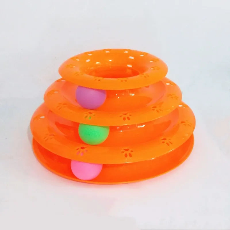 Close-up of a cat playing with a ball inside an interactive play pyramid tower, promoting kitten activity.