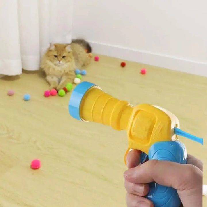 Active cat batting at a launched plush ball, showcasing the interactive fun of this cat toy accessory