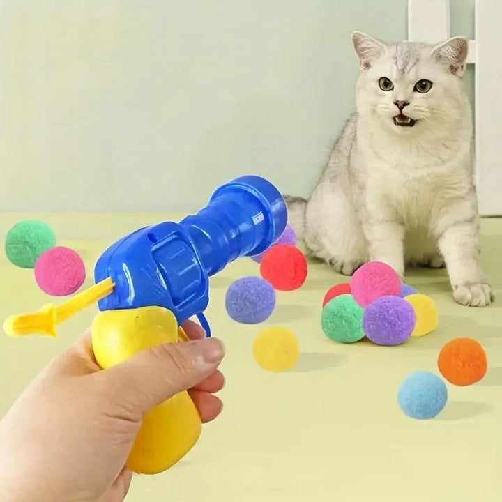 Interactive cat toy launcher gun with soft plush balls for indoor cat exercise and fetch fun.