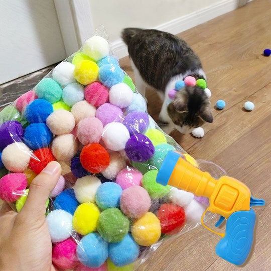 Cat toy launcher gun with multiple soft plush balls, perfect for engaging pet enrichment activities.