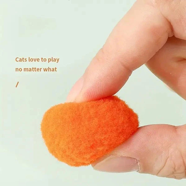 Cat running after a soft ball launched by the interactive cat toy gun, enriching pet supplies.