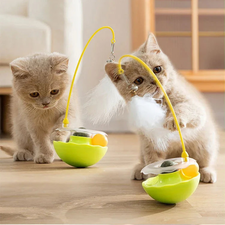 Interactive cat toy tumbler with colorful feathers and an internal bell encouraging pet playtime.