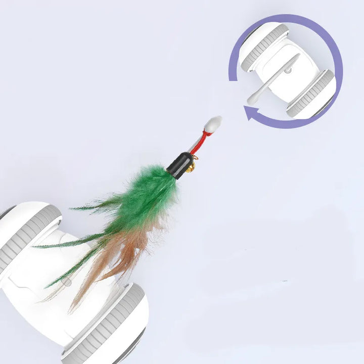 Cat batting at a feather attachment on an automatic interactive cat toy with a red base