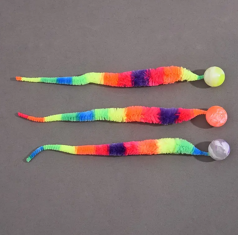 Multicolor cat toy interactive with plush tail and attached ball, a fun pet supply.
