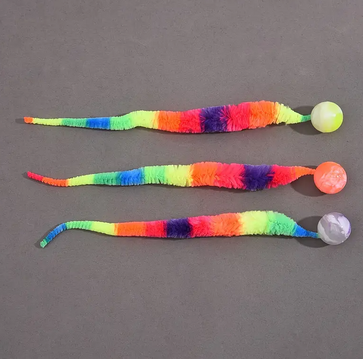 Multicolor cat toy interactive with plush tail and attached ball, a fun pet supply.