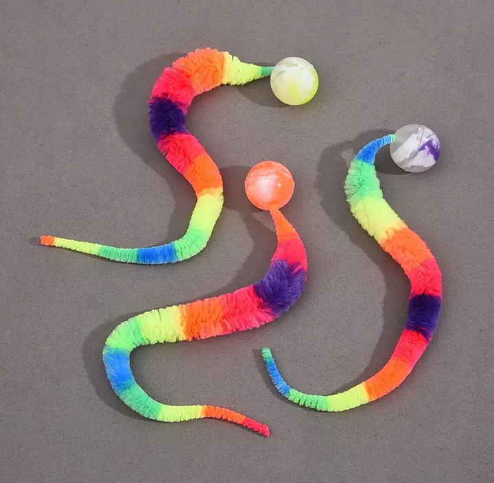 Unicolored interactive cat toy with a plush tail and bouncy ball, great for fidget play.
