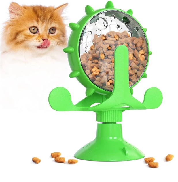 Cat playing with an interactive feeder toy, a fun treat dispenser for mental stimulation.