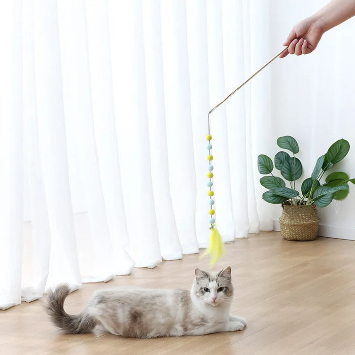 Interactive cat wand toy with colorful pompoms & soft feathers, perfect for engaging playtime.