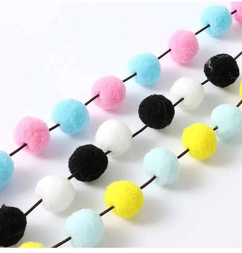 Dynamic interactive cat wand toy with an array of pompoms and feathers, suitable for all cat breeds.