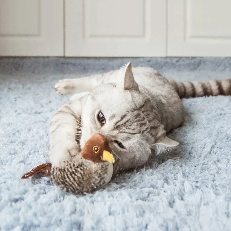 Hand holding interactive chirping bird cat toy, showcasing size and detail
