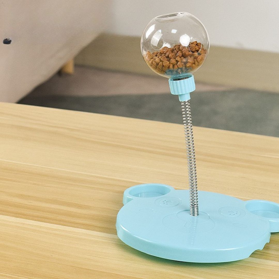 Happy dog playing with a wiggling treat dispenser toy, an interactive pet supply