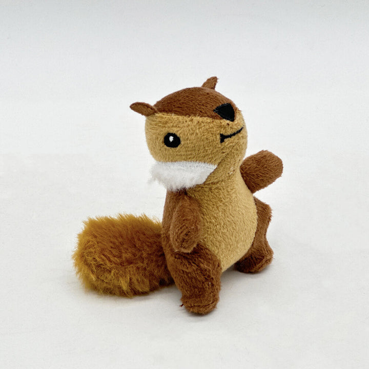 Six plush squeaky squirrels from an interactive dog puzzle toy with a brown tree trunk base