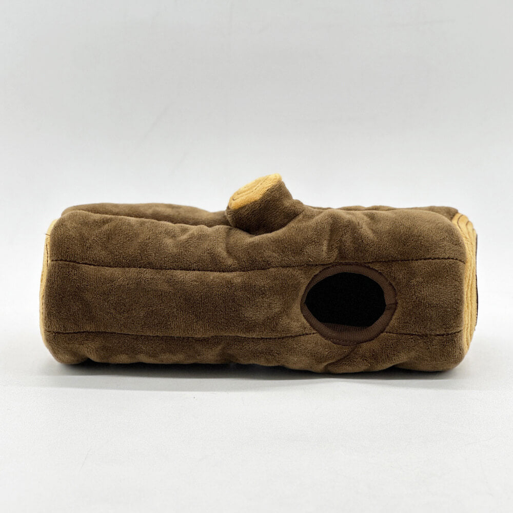 Top view of interactive dog puzzle toy: brown tree trunk with multiple squirrel hiding spots