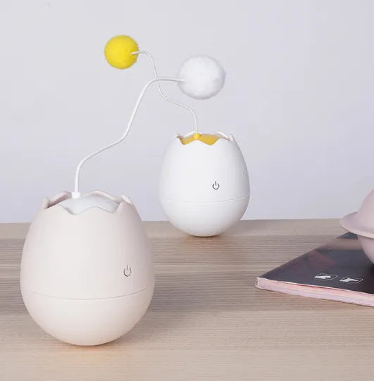Interactive cat fun: Egg-shaped toy featuring a captivating moving ball for pets