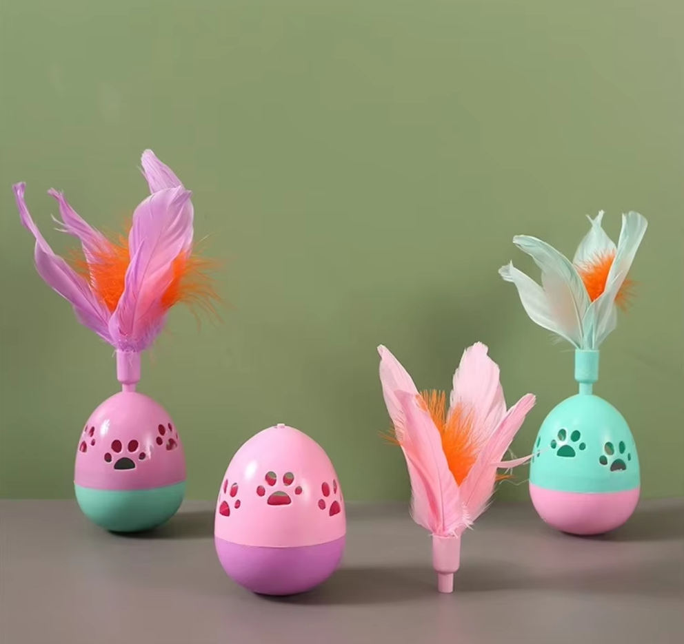 Close-up of an interactive cat toy ball with colorful feathers for playtime