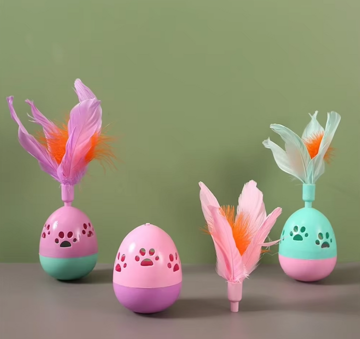 Close-up of an interactive cat toy ball with colorful feathers for playtime
