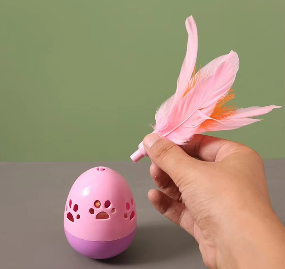 Cat batting an interactive feathered ball toy, promoting active playtime