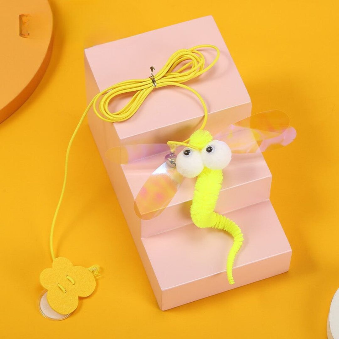 Interactive cat toy with a bell dangling from a door frame, encouraging playtime.
