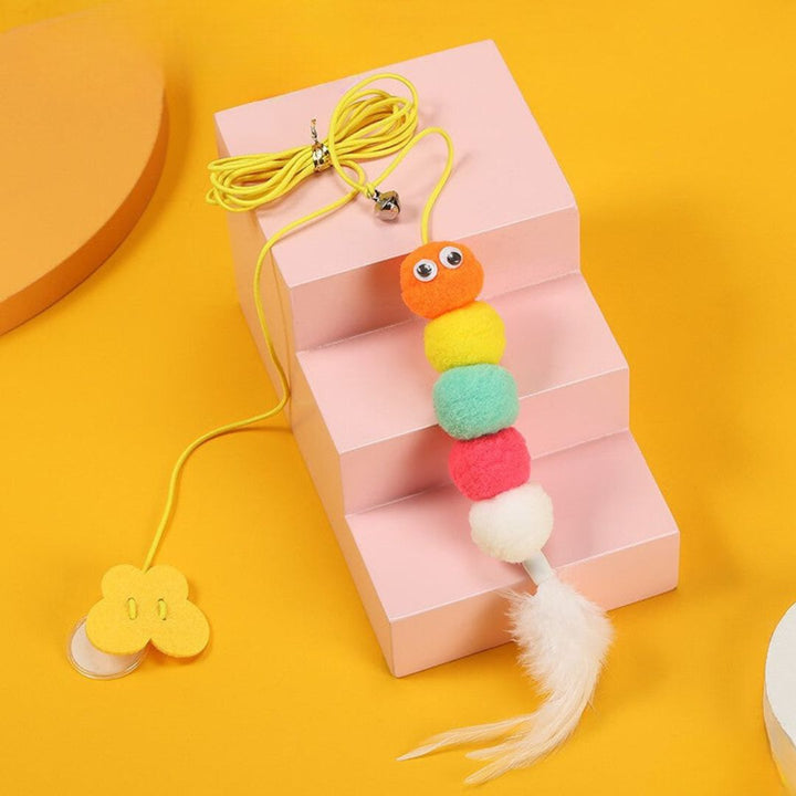 Feline enrichment: a cat staring intently at a dynamic suspended bell toy.