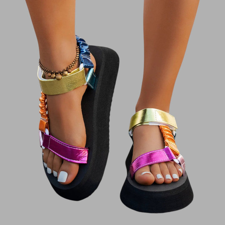 Chic women's platform sandals with iridescent straps, a fashionable statement for summer and elevated evening style.