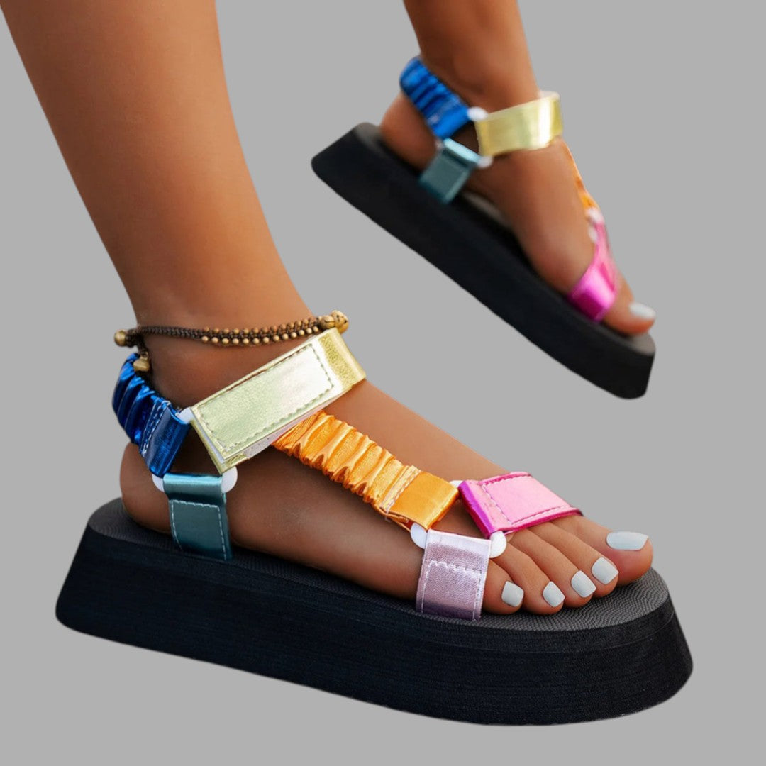 Women's chic platform sandals with iridescent finish, offering elevated style for fashionable summer shoes.