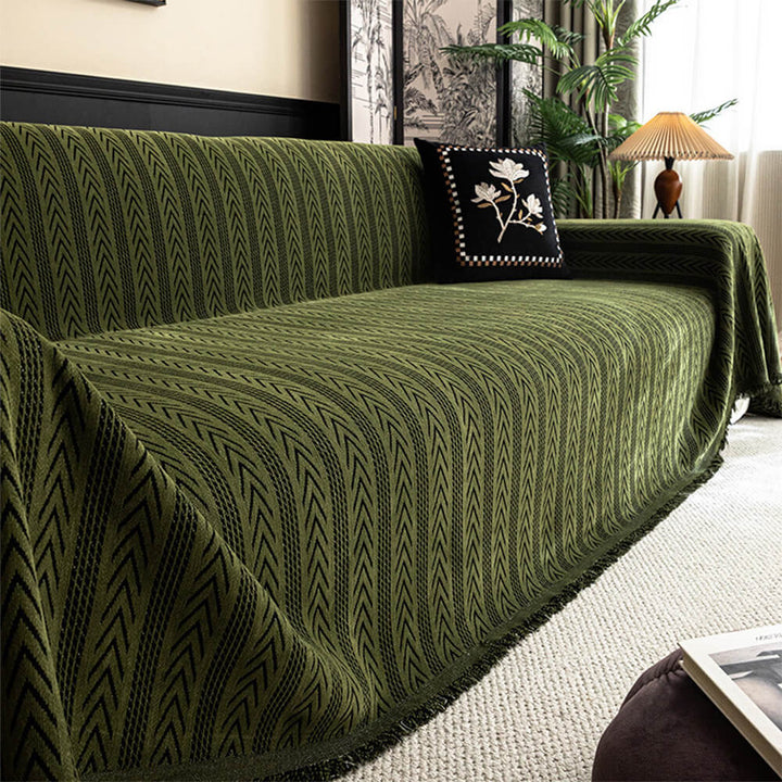 Chenille sofa cover with prominent jacquard detailing and charming tassels, non-slip design