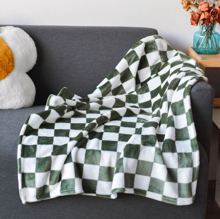 Dog comfortably sleeping on a soft chequered flannel pet blanket, khaki and yellow design