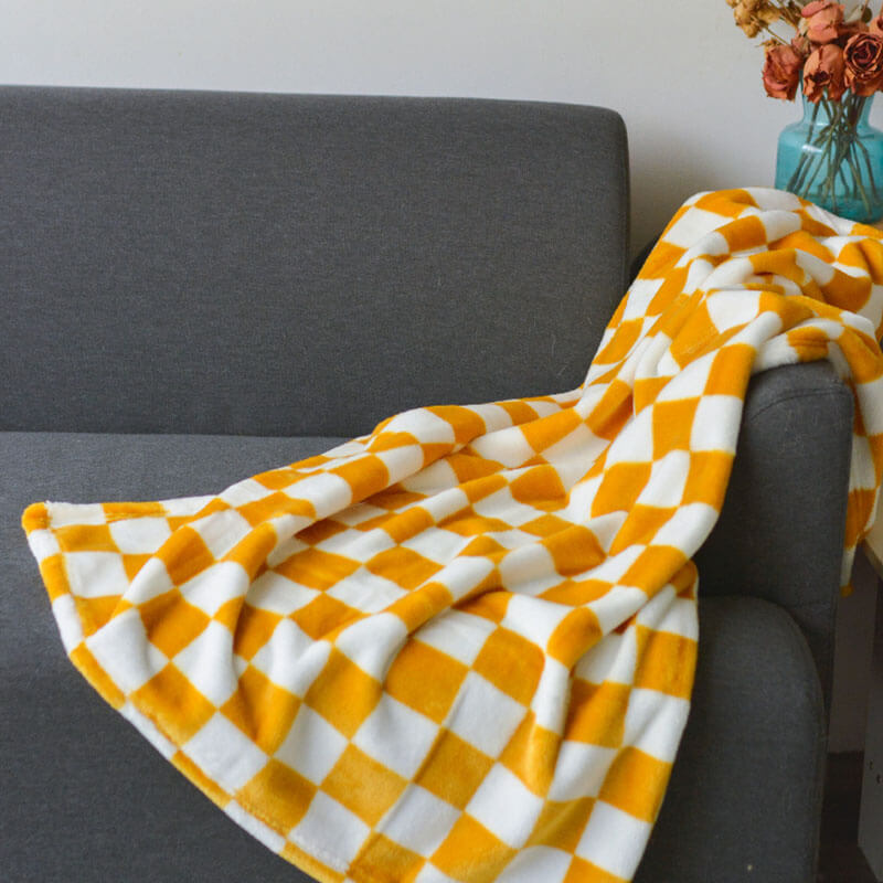 Detailed view of the chequered pattern on a soft flannel pet blanket for dogs and cats