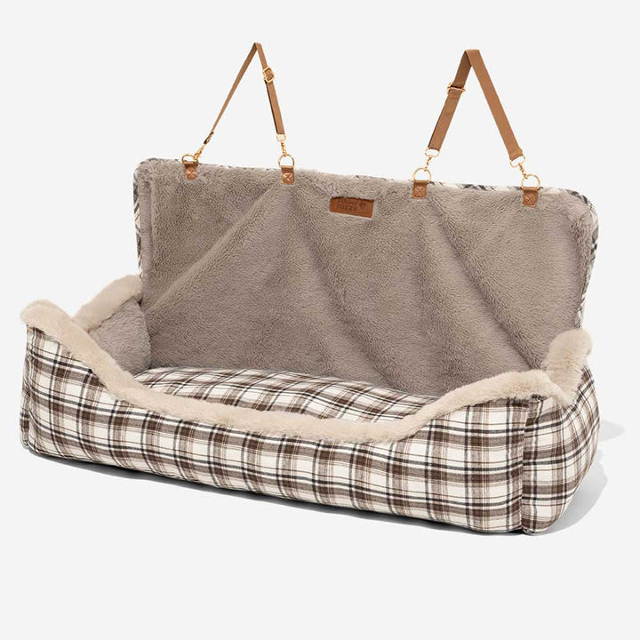 Plush brown dog booster car seat, perfect travel accessory for comfortable pet journeys.