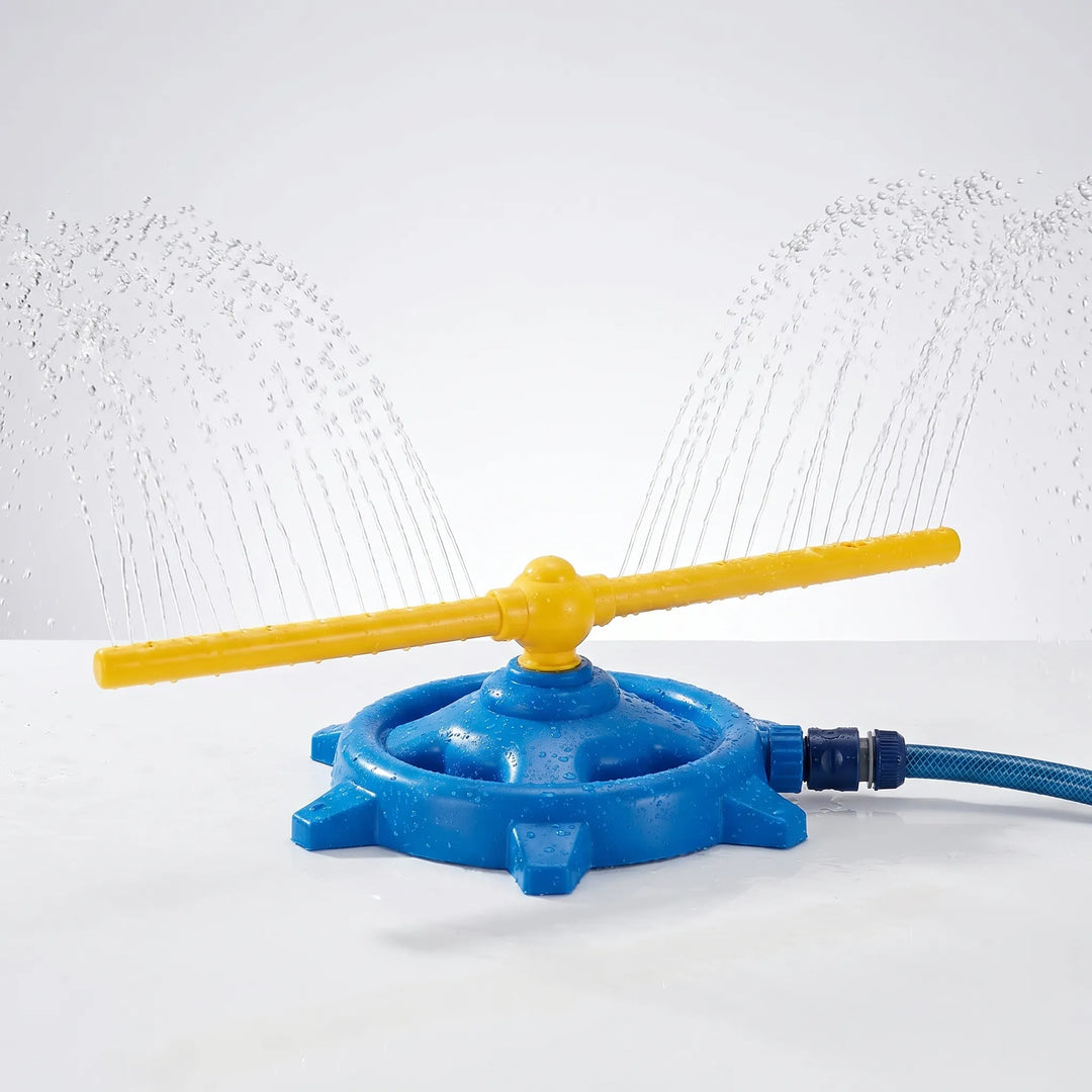 Children laughing and playing with a colorful outdoor rotating water sprinkler in a sunny garden.