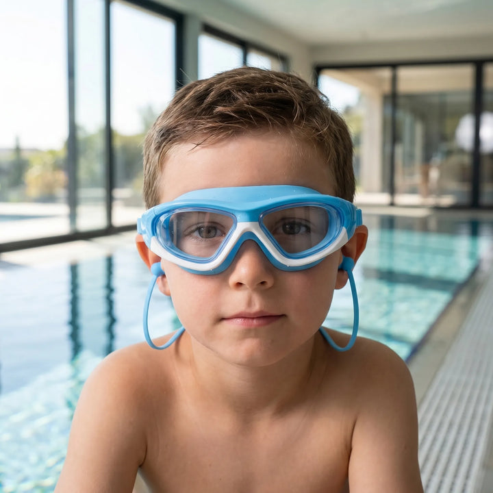 Kids' anti-fog swim goggles with UV protection, adjustable strap, and integrated earplugs for comfortable swimming.