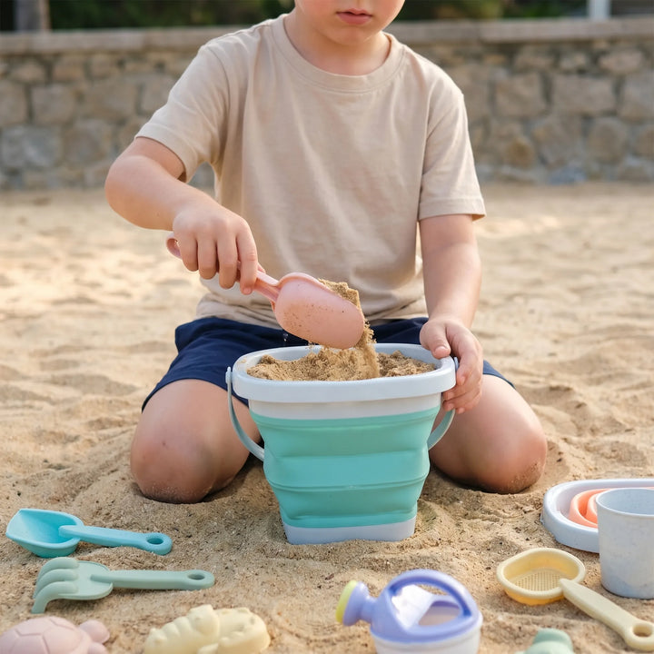 Kids' collapsible beach toy set for sand & water play. Includes bucket, shovel, molds. Easy travel summer fun for children.