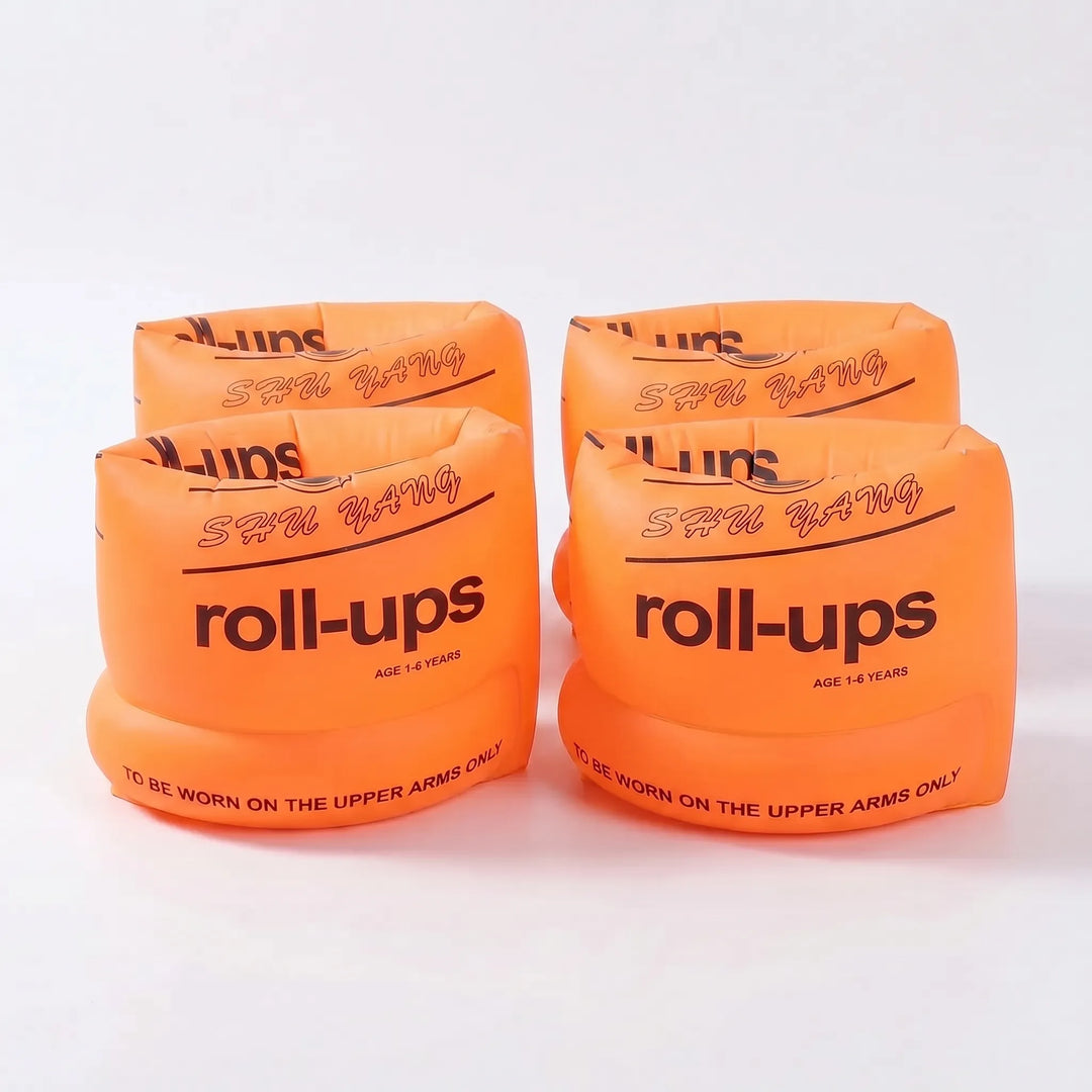 Kids using bright inflatable swim armbands for fun and safe swimming practice in the pool.