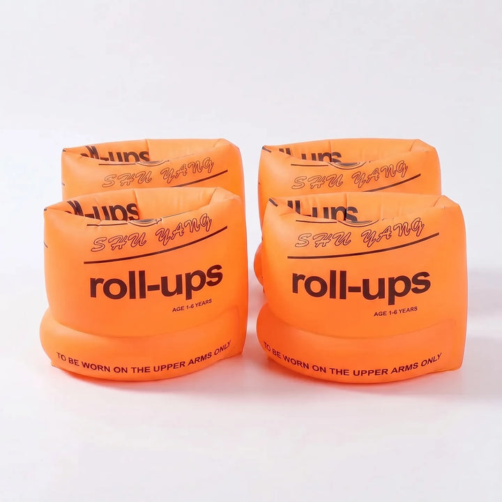 Kids using bright inflatable swim armbands for fun and safe swimming practice in the pool.
