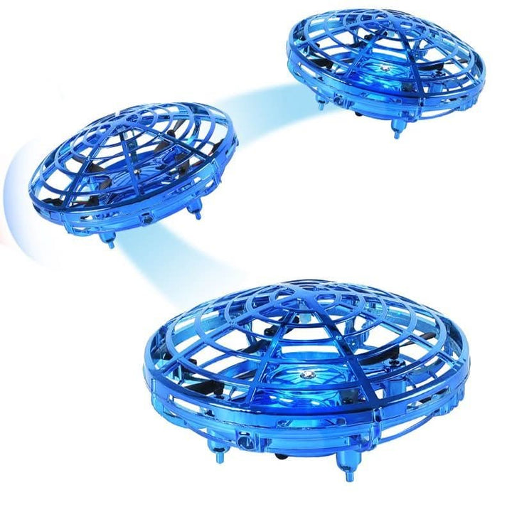 Happy child playing indoors with an interactive UFO drone, enhancing motor skills with hand gesture control.
