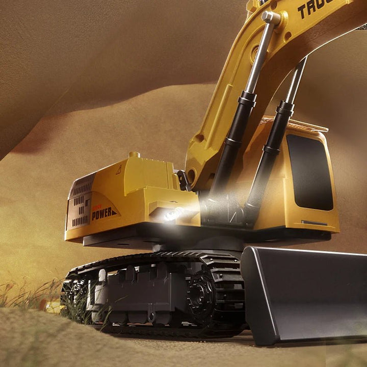 Close-up of yellow metal RC excavator toy. Detailed construction vehicle for kids with remote control, lights, sounds.
