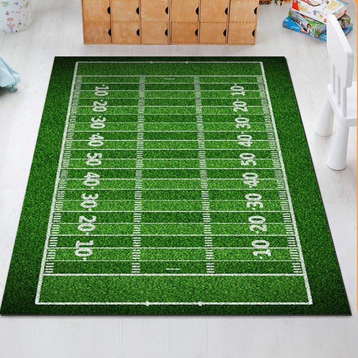 Detailed close-up of a kids' anti-slip sports field area rug, showing vibrant green football pitch markings.