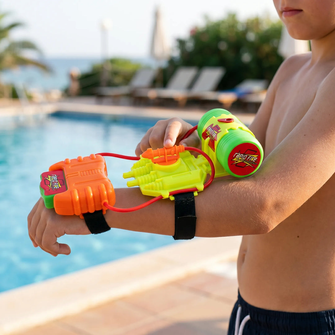 Smiling kid blasting water with a vibrant wrist water toy during active outdoor summer fun and water games.