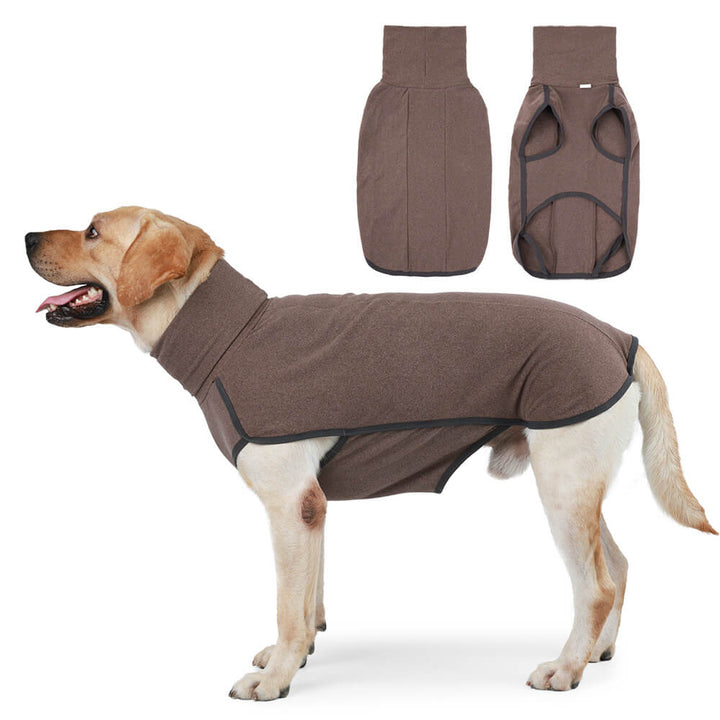 Side view of a large dog wearing a black windproof water-resistant winter coat, deep in snow.