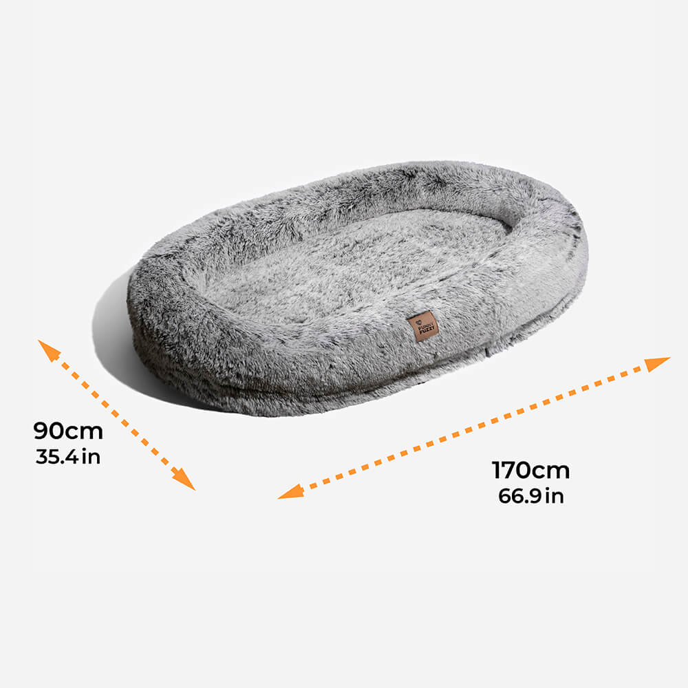 Plush grey faux fur human dog bed, promoting deep sleep and shared relaxation