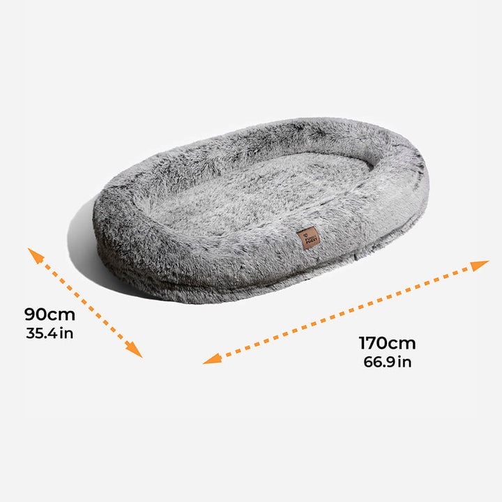 Plush grey faux fur human dog bed, promoting deep sleep and shared relaxation