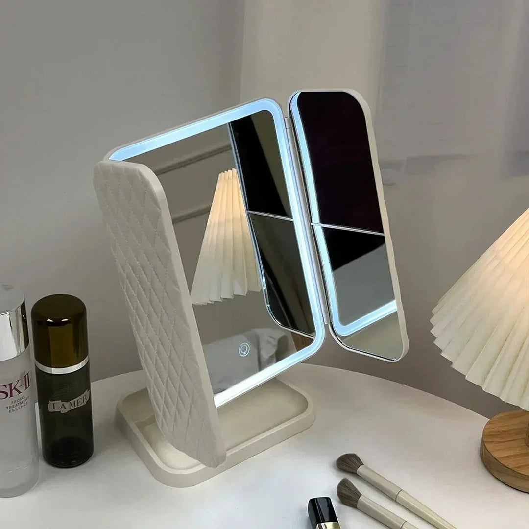 Compact tri-fold LED makeup mirror, offering wide views & 3 light colors for flawless beauty application.